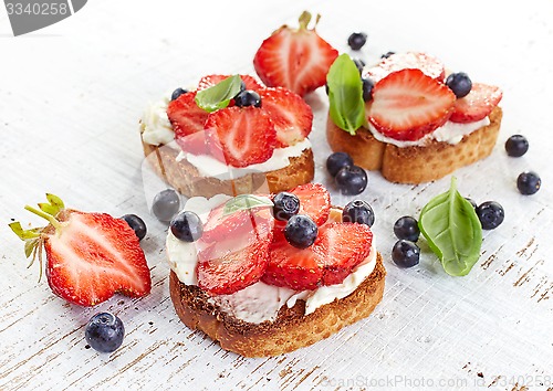 Image of toasted bread with cream cheese and strawberries