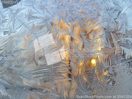 Image of Ice pattern and sunlight on winter glass