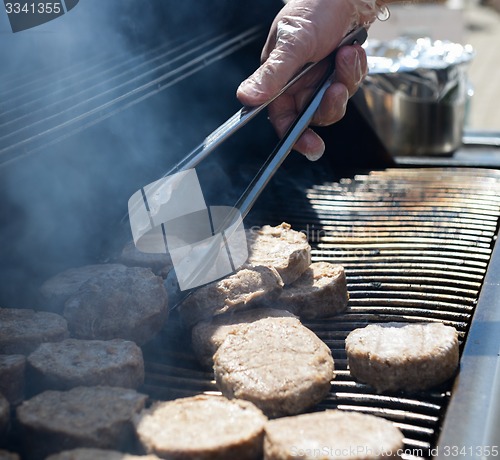 Image of cooking steaks on a hot grill