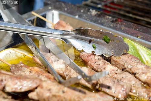 Image of Juicy roasted kebabs on the metal tray