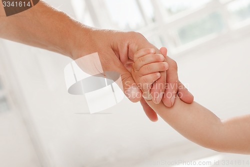 Image of father giving hand to a child
