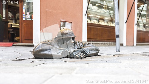 Image of BRATISLAVA, SLOVAKIA - MAY 07, 2013: Cumil (The Watcher) - famous statue of man peeking out from under a manhole cover.