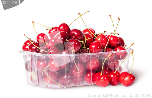 Image of Red sweet cherries in plastic tray rotated and three near