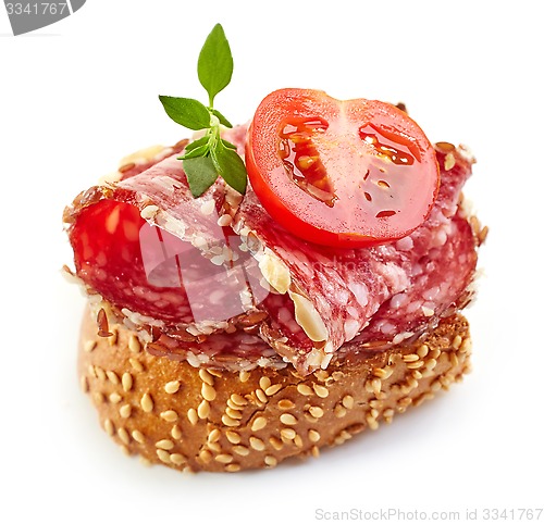 Image of toasted bread with salami and tomato