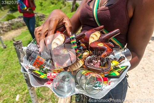 Image of OCHO RIOS, JAMAICA - MAY 07, 2012:  Souvenirs on the glass tray in the hands of the local women