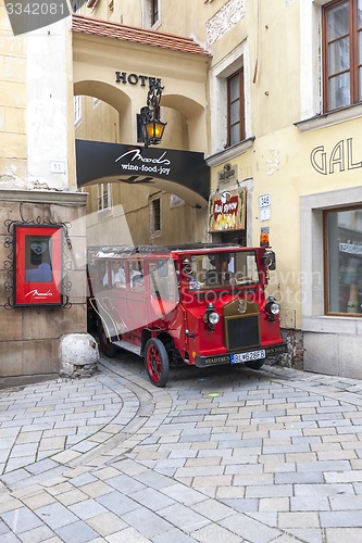 Image of BRATISLAVA, SLOVAKIA - MAY 07 2013: Tourists in a bus on the streets in Old Town 