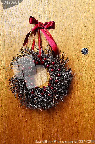 Image of wooden door with a Christmas wreath