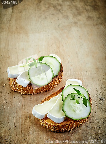 Image of toasted bread with brie and cucumber