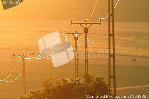 Image of electric pillars at sunset