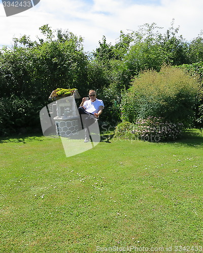 Image of Man in cottage garden