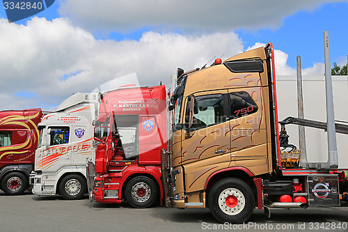 Image of Lineup of Colorful Volvo and Scania Trucks
