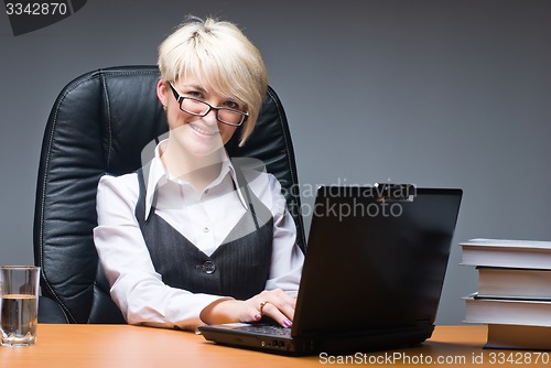 Image of Attractive businesswoman with laptop