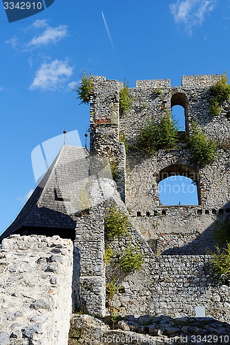 Image of Contrail of the jet plane above ruin of Celje medieval castle in Slovenia