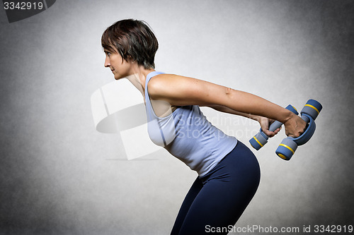Image of Middle aged woman with dumbbells