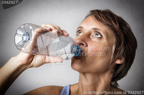 Image of Middle aged woman drinking