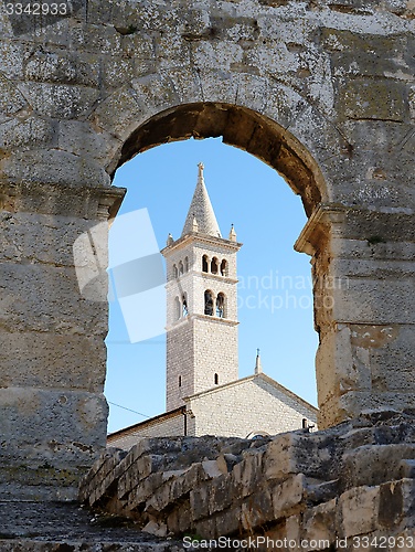 Image of Bell tower of Saint Anthony Church in Pula, Croatia seen through the arc of Pula Amphitheater