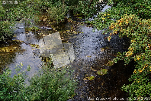 Image of Surface of travertine pond in autumn