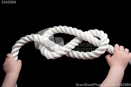 Image of Baby hands holding overhand knot