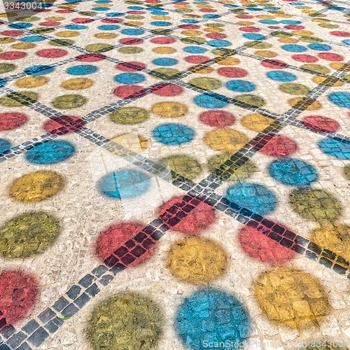 Image of Multicolored Shadows from Decorative Balls on Paving Stone