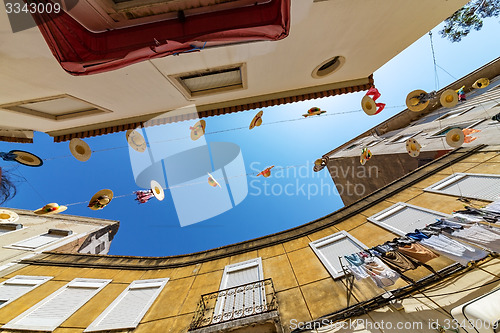 Image of City Streets Decorated with Straw Hats