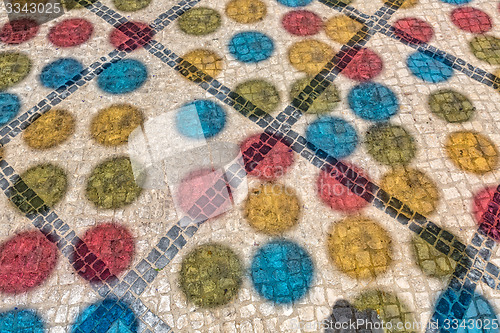 Image of Multicolored Shadows from Decorative Balls on Paving Stone