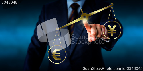 Image of Euro Sign Outweighing The Yuan On A Golden Scale