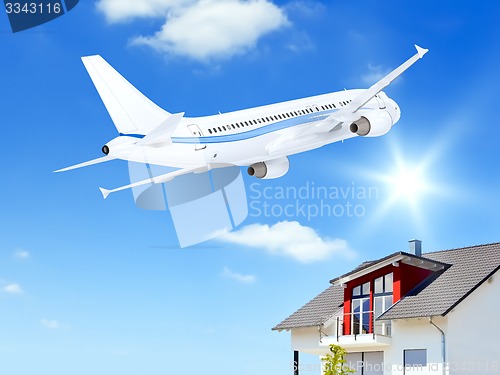 Image of airplane over house