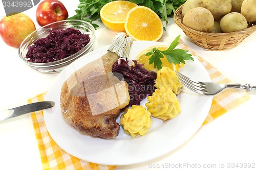 Image of delicious Duck leg with red cabbage