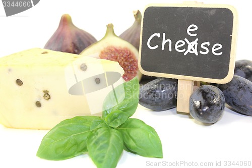 Image of Piece of cheese with pepper and blackboard