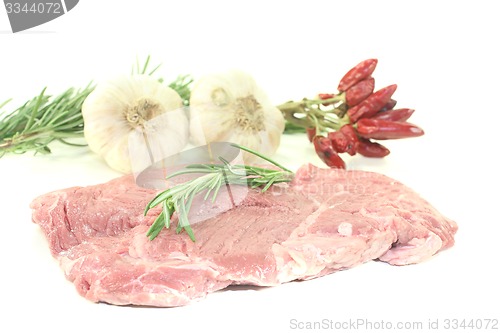 Image of raw Ribeye steak with garlic and rosemary