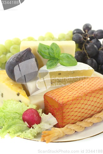 Image of Pieces of cheese with grapes