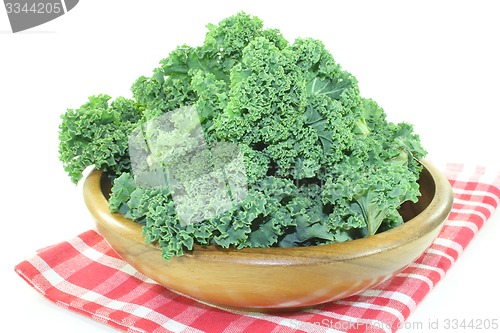 Image of Kale in a wood bowl on napkin