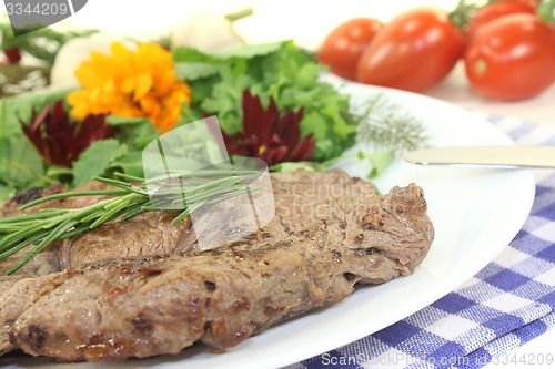 Image of fried Sirloin steak with wild herb salad