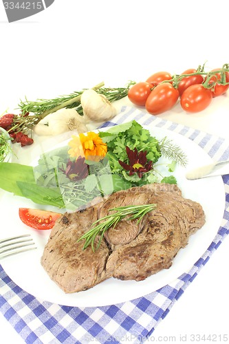 Image of fresh Sirloin steak with wild herb salad