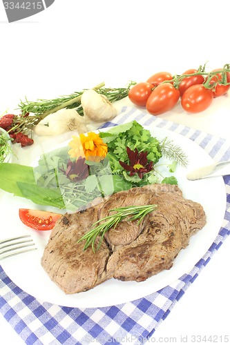 Image of fresh Sirloin steak with wild herb salad