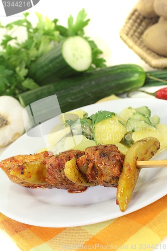 Image of Potato-cucumber salad with fire skewers and chilli