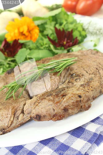 Image of Sirloin steak with wild herb salad and rosemary