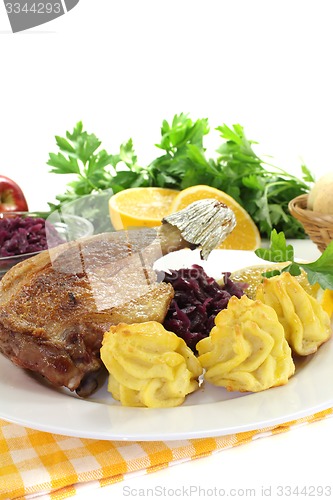 Image of hot Duck leg with red cabbage