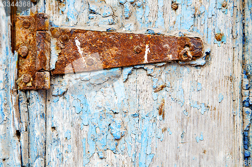 Image of morocco in  old wood  facade home and rusty safe padlock 