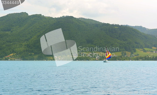 Image of Sailboat with a colourful sail on an alpine lake