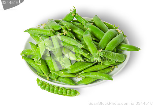 Image of Opening and closing pea pods on white plate top view