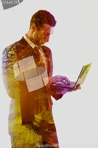 Image of double exposure of business man who working on laptop and alley 