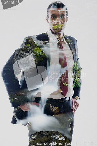 Image of double exposure of business man and creek in forest background