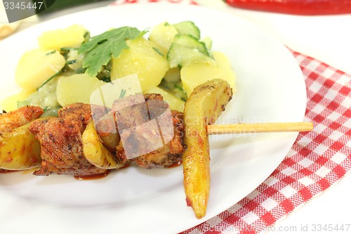 Image of fresh Potato-cucumber salad with fire skewers