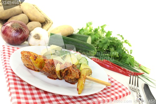 Image of Potato-cucumber salad with fire skewers and chilli