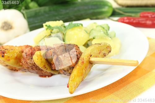 Image of Potato-cucumber salad with fire skewers