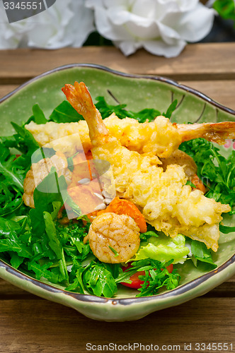 Image of fresh Japanese tempura shrimps with salad