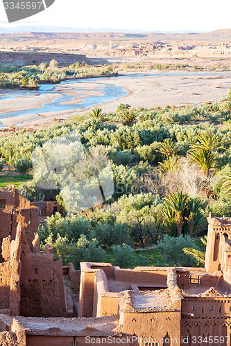 Image of sunset in africa old construction near       the river blue