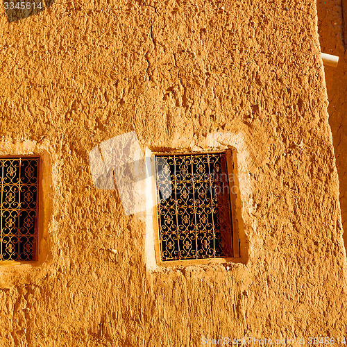 Image of   yellow window in morocco africa old construction and brown wal