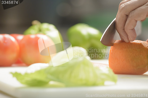 Image of Female Cook Cutting Carrot